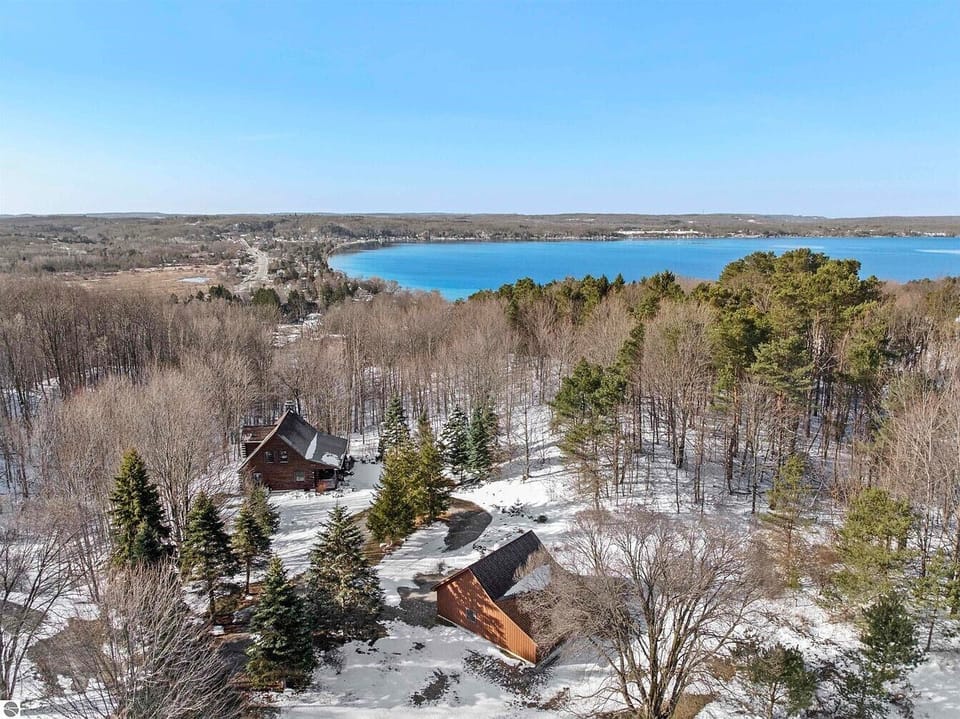 EXTERIOR:  An aerial view of the cabin with Crystal Lake in the background.