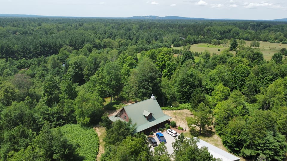 EXTERIOR:  A summertime aerial view of the property with Crystal Mountain in the background.