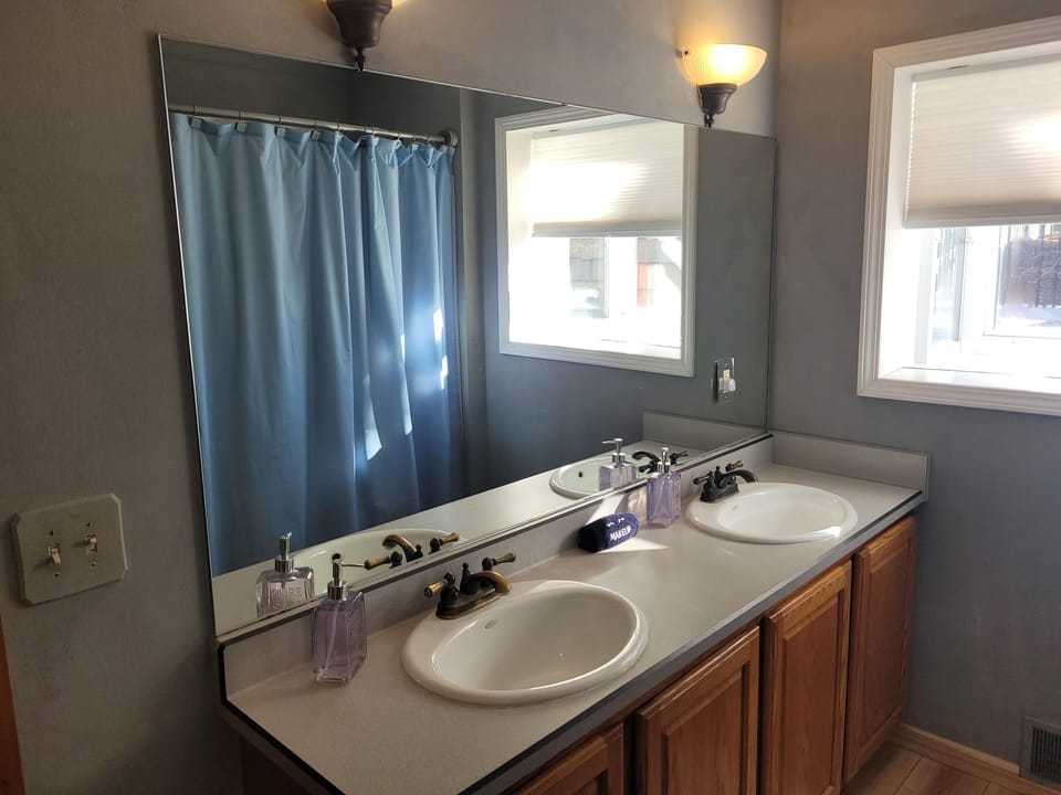BATHROOM #1 (MAIN FLOOR):  This is a full private ensuite bathroom for Bedroom #1.  It includes a combination tub and shower.