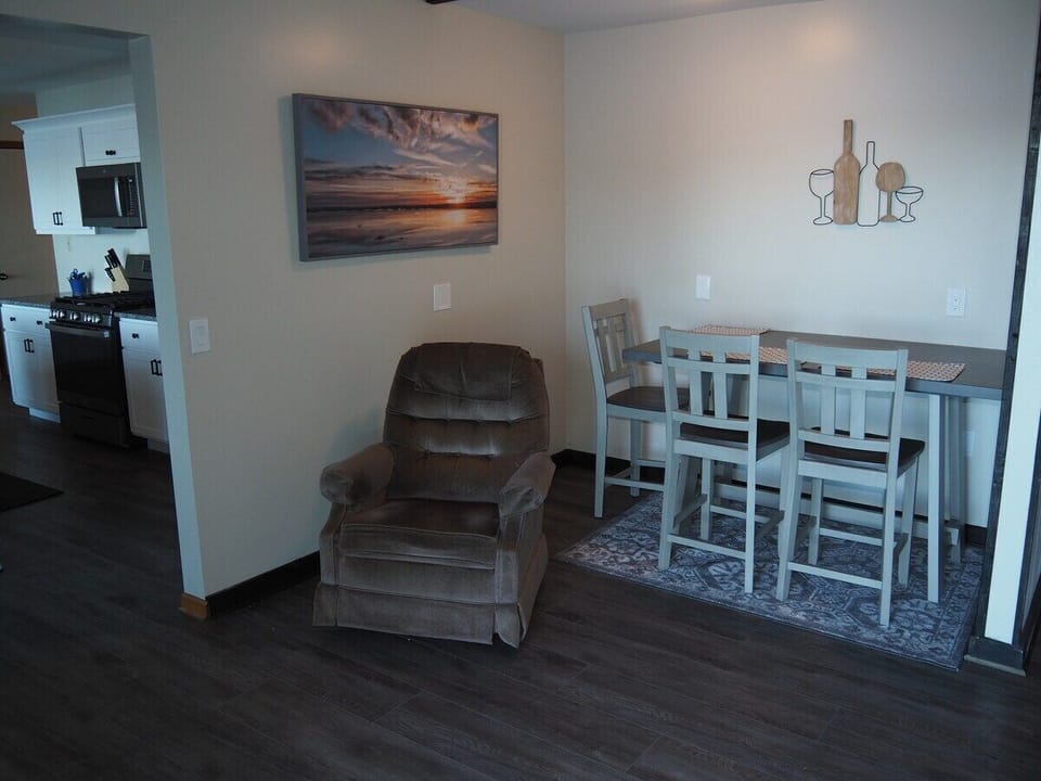 DINING AREA:  In-between the kitchen and the living room is a small dining area and cozy chair that's in front of the television.