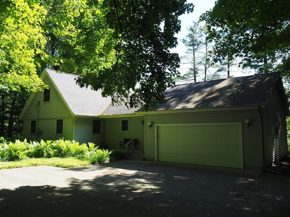 EXTERIOR:  The front of the cottage, showing the garage that has plenty of room for 1 car (which is extremely convenient in the winter).