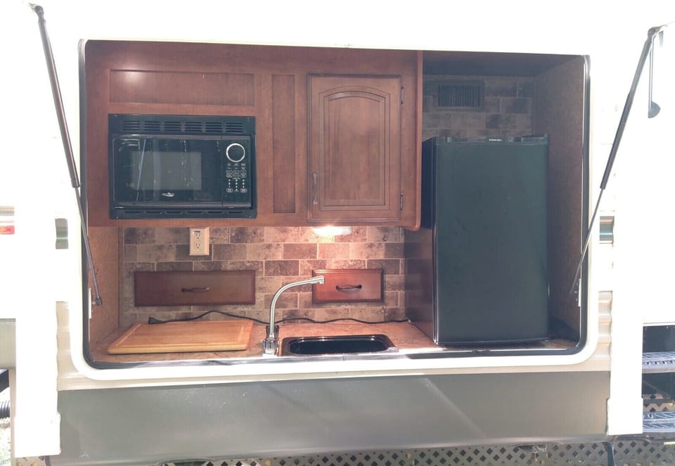 EXTERIOR:  The cute little outdoor kitchen that is included.