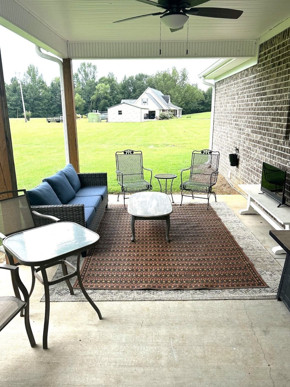 Covered patio with TV and Cornhole game
