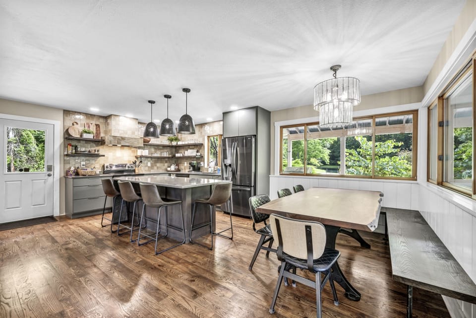 The open layout and large windows make the kitchen feel spacious and airy.