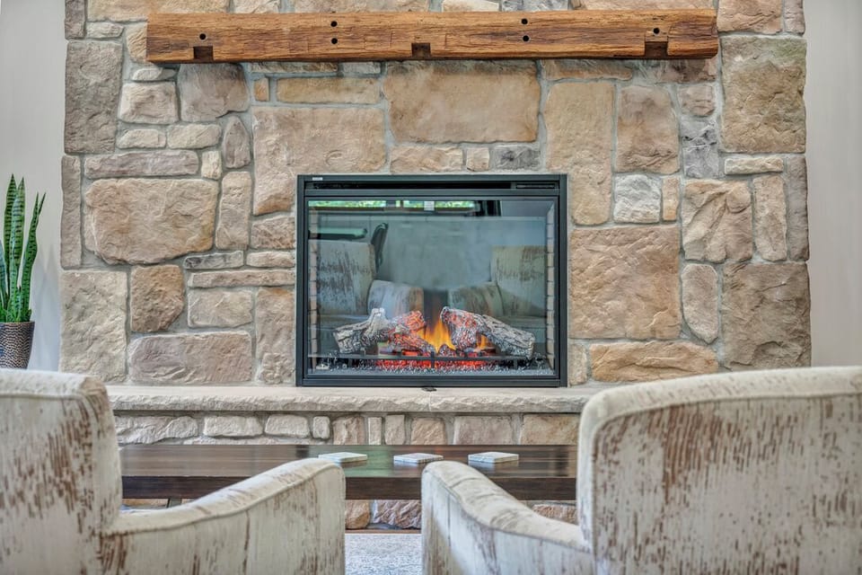 The stone fireplace really adds a rustic, cozy vibe to the room.