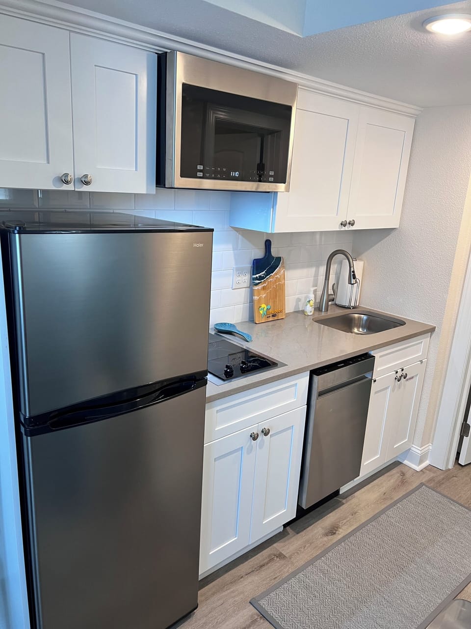 Kitchenette fully loaded with cookware, utensils, toaster, blender, dishwasher