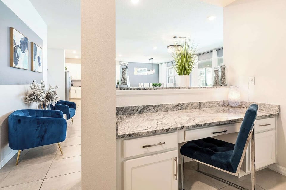 The workspace off the living room is a cozy and functional nook designed for productivity. 