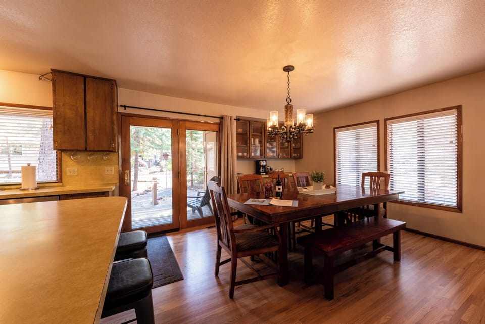 Large dining room table seats 8 plus 3 stools at the counter.