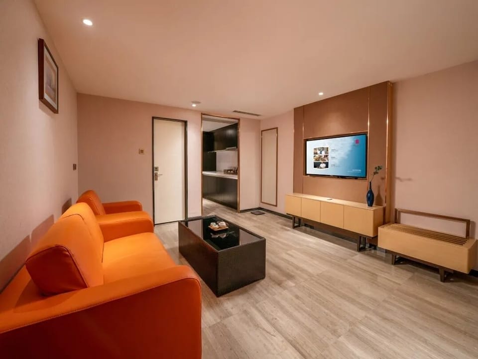 Standard Suite | Living room | 65-inch LCD TV with cable channels