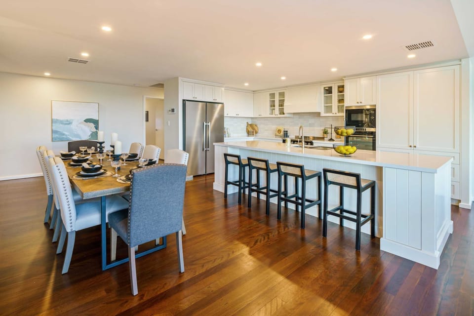 The open-plan living and dining room is illuminated by natural lighting.