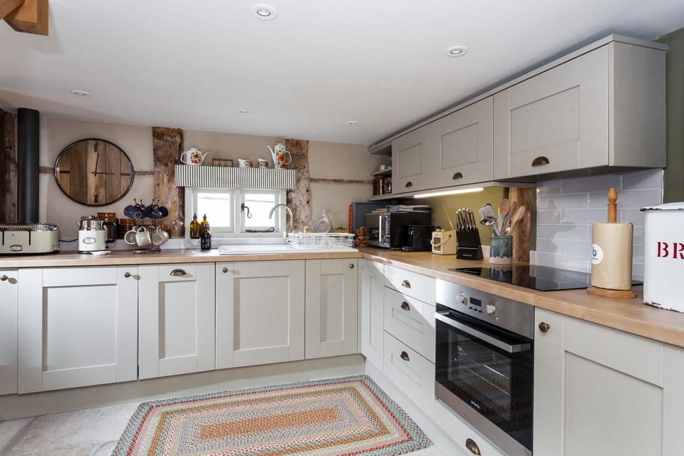 Kitchen with an electric oven and hob, dishwasher and coffee machine