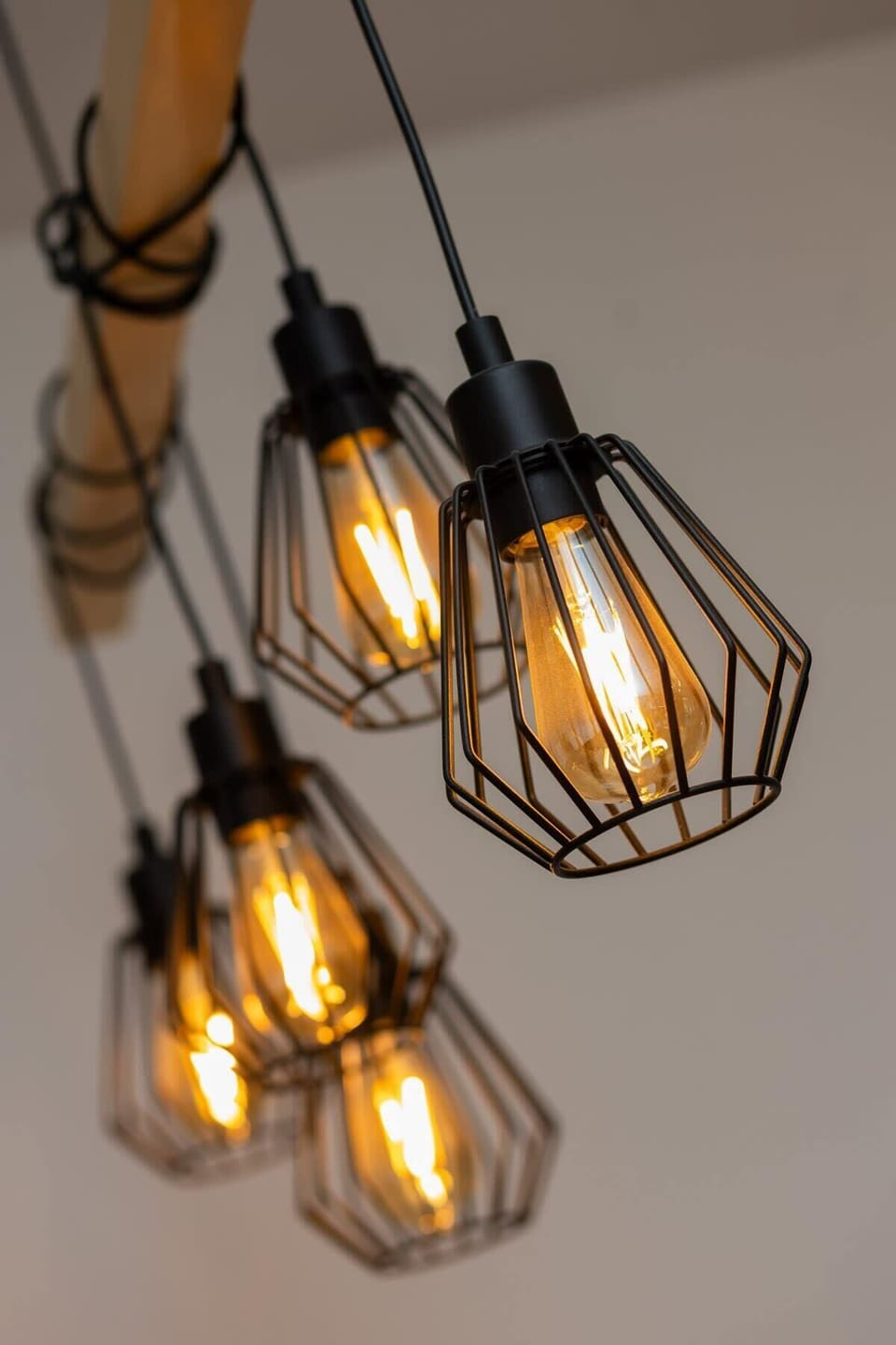 A close-up of industrial-style pendant lights with black wireframes, adding a modern touch to the decor.
