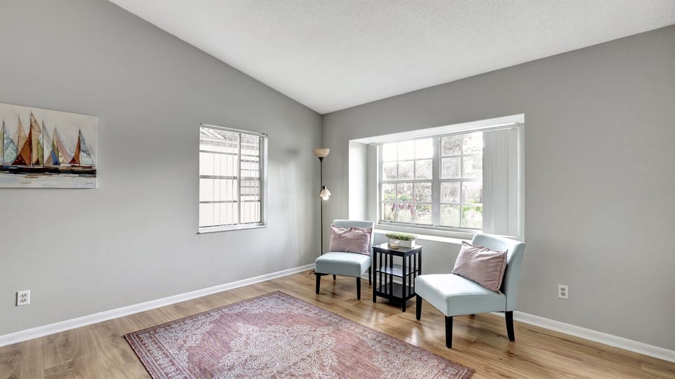 An inviting extra seating nook bathed in natural light by the window.