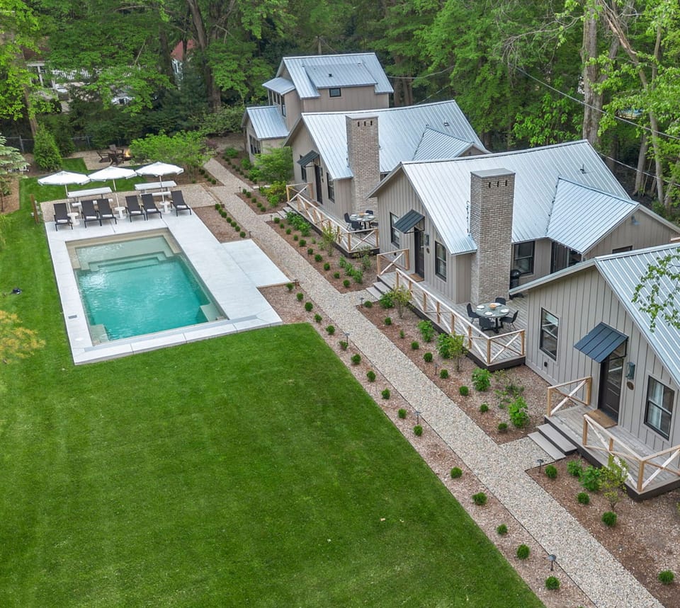 Embrace the tranquility of this beautiful residence featuring a refreshing pool and a vibrant lawn.