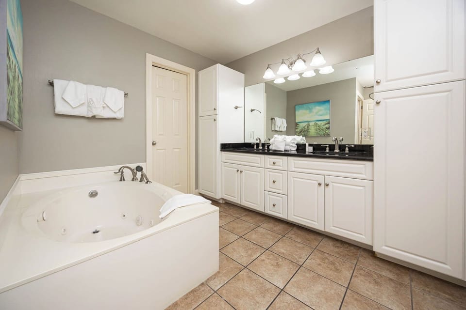 Indulge in a soothing soak in your spacious jetted tub in the master, surrounded by serene decor and thoughtful design
