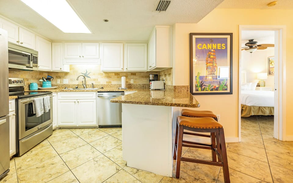 Savor morning coffee at the bar seating while enjoying the inviting kitchen vibe, perfect for family fun