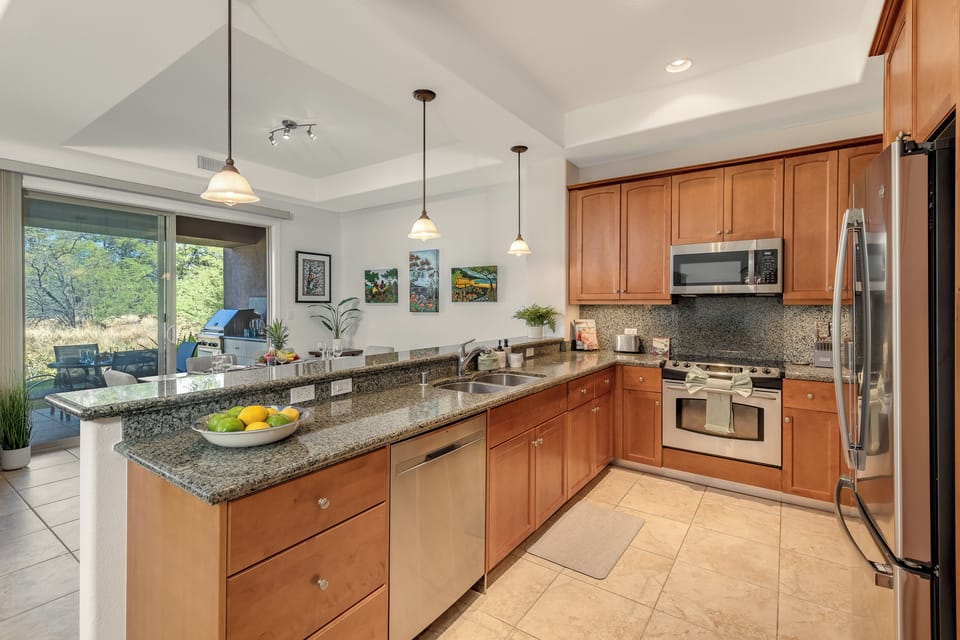 The chef-ready kitchen features granite counters and stainless appliances.