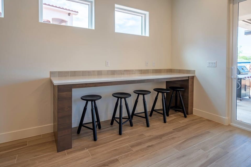 Bistro bar seating for an extra 5 people next to dining table