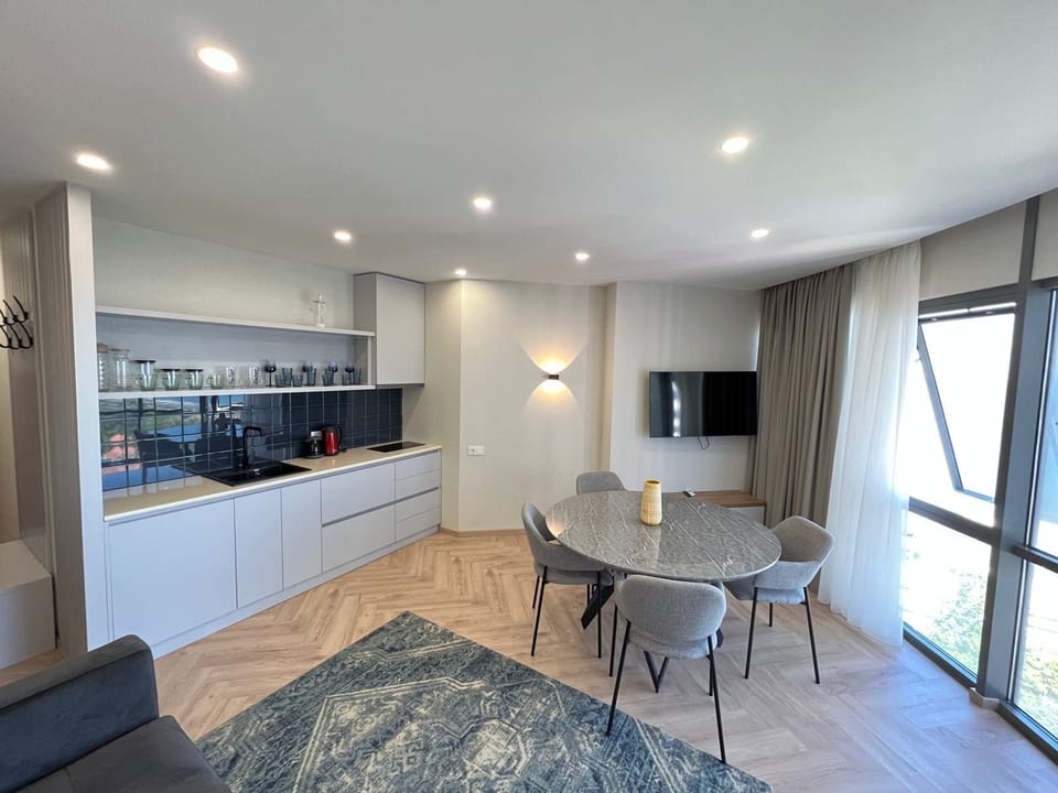 Deluxe Apartment | Living area | 40-inch Smart TV with cable channels