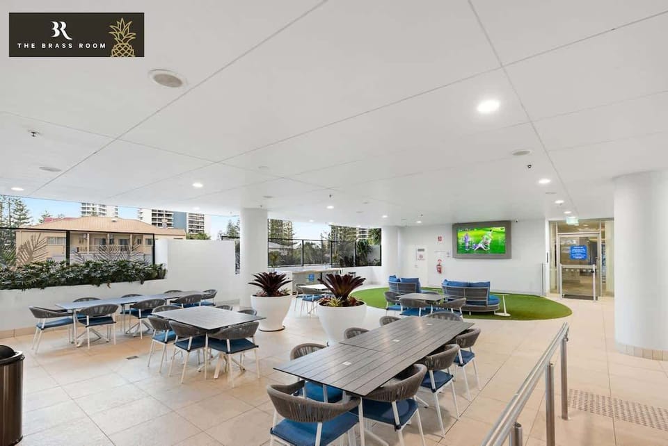 The building common area is next to the pool and hot tub. Has a BBQ area great for functions. It's the perfect place to enjoy a meal with family or friends, offering a welcoming atmosphere for any occasion.