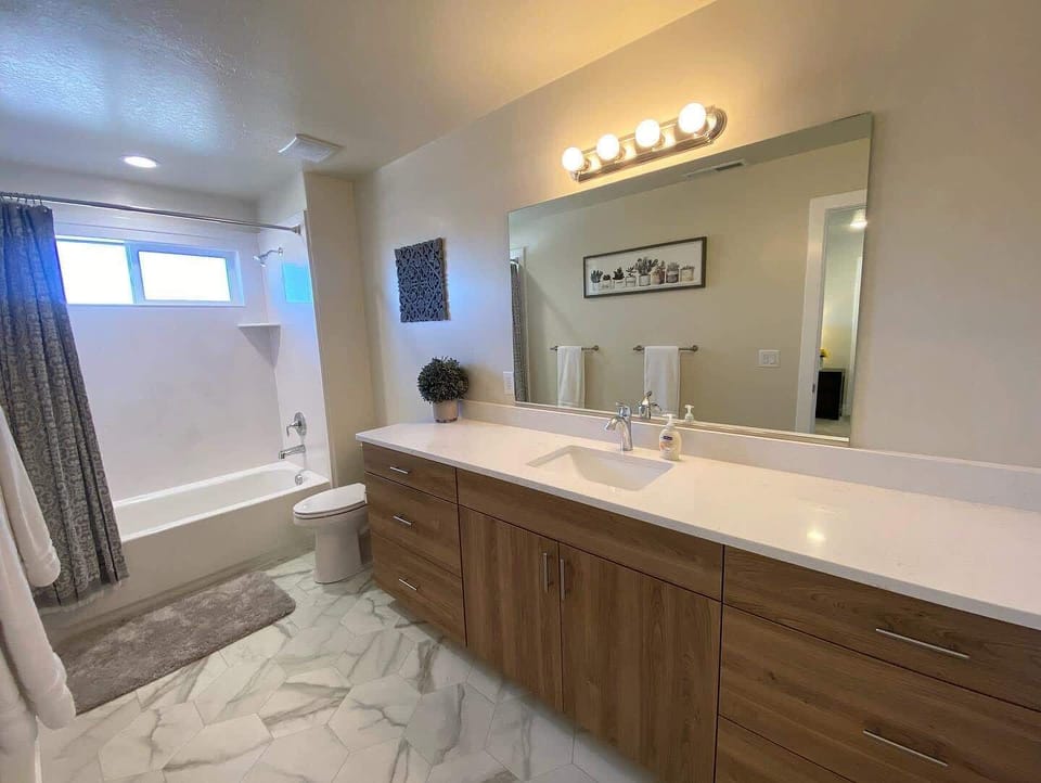 The ensuite bathroom offers a generous vanity and a shower and tub for your comfort.