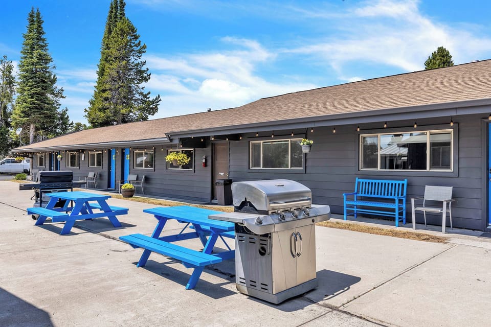 Outside patio with benches, picnic tables and grills for communal use
