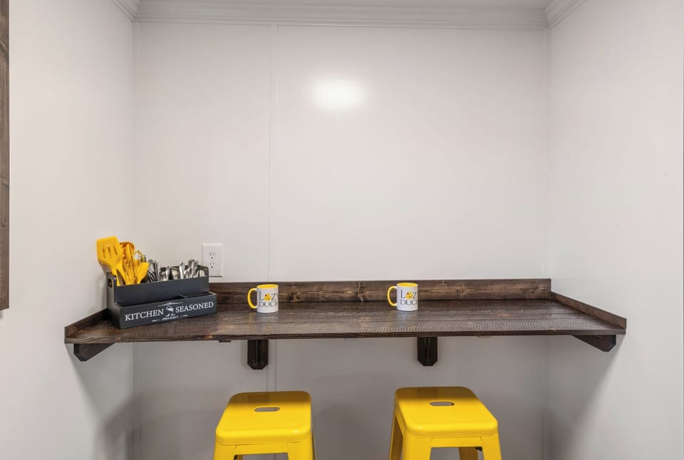 Bar stools, bar countertop, cooking and eating utensils