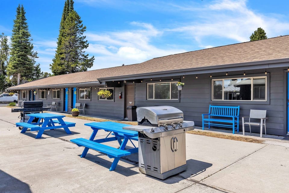 Outside patio with benches, picnic tables and grills for communal use