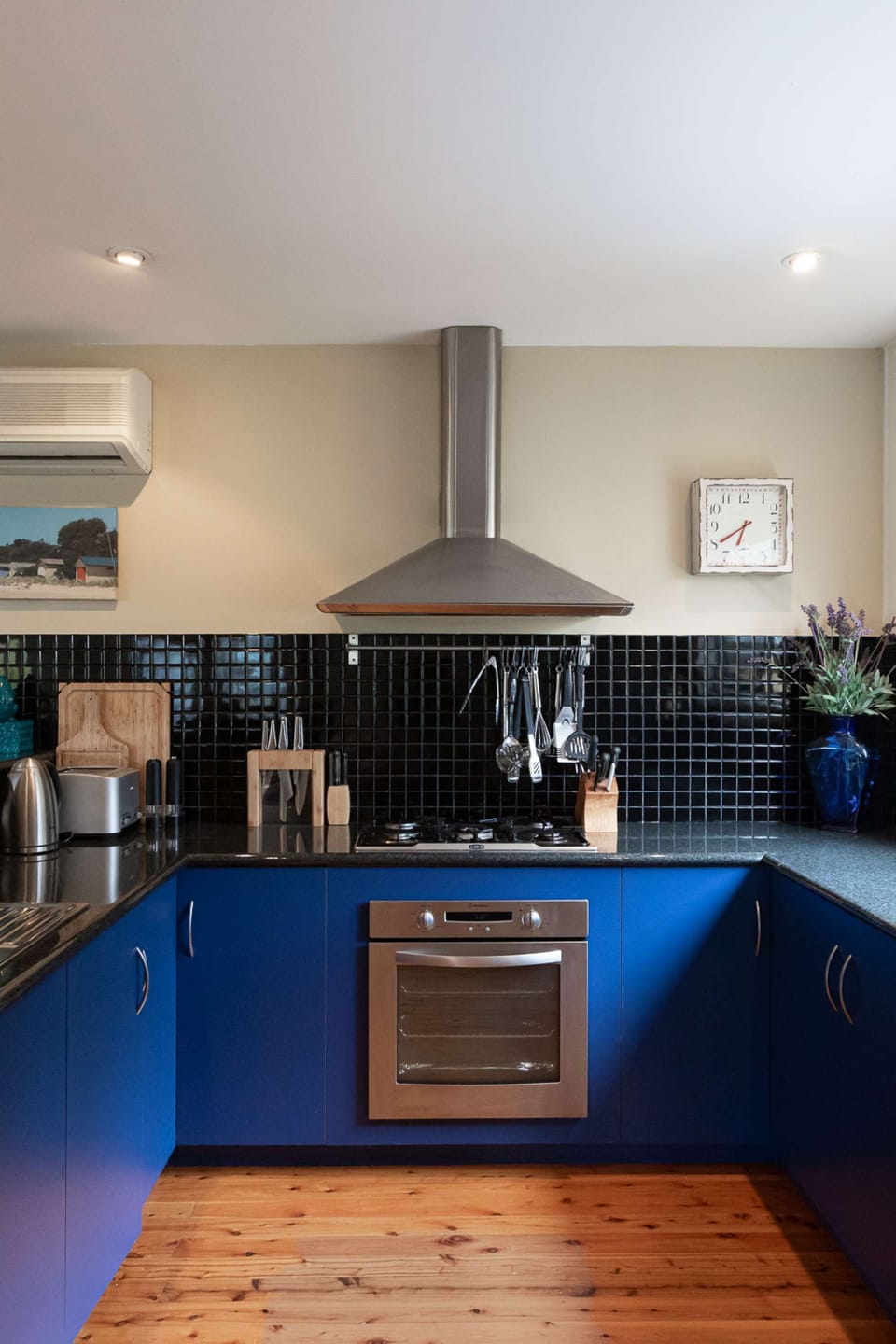 Modern kitchen with gas stove, electric oven, Nespresso coffee machine, sand-which press and appliances for entertaining and cooking for a large group