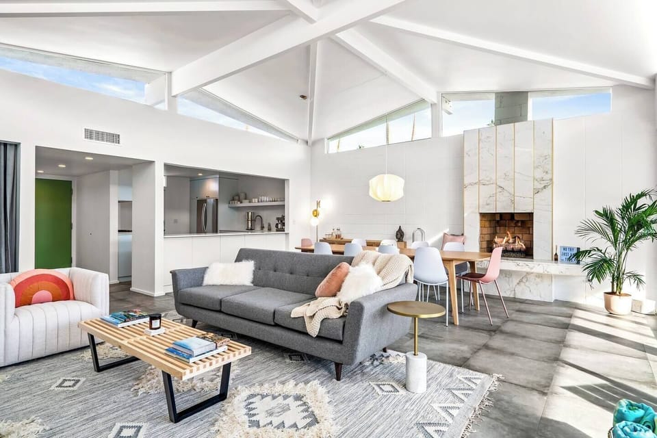 Main living space with dramatic umbrella ceiling, clerestory windows, and walls of glass to take in the phenomenal view! See previous photos for latest update showing the new gorgeous wall decor behind the dining table. 
