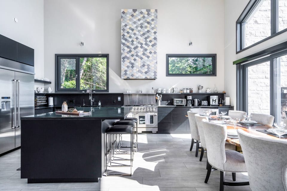 Our sleek, modern kitchen is fully equipped with stainless steel luxury appliances including a wine fridge and large island.