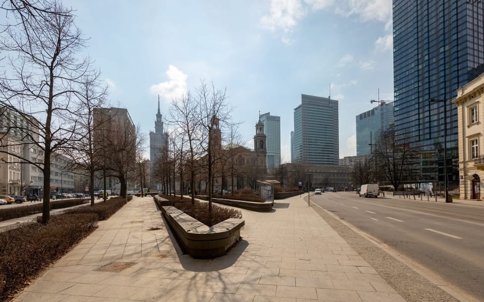 A view of the surrounding urban area, featuring wide pedestrian paths, modern buildings, and a peaceful atmosphere.







