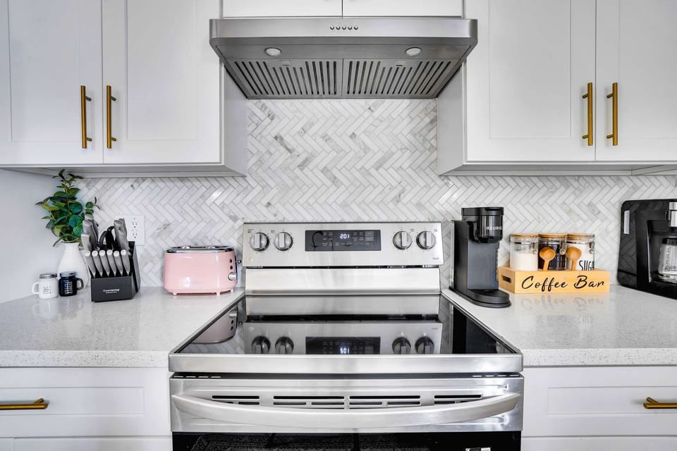 Fully stocked kitchen with a stainless steel stove.