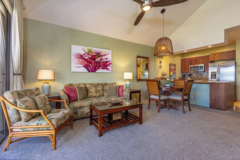 Step into your bright tropical haven, where island-style comfort meets modern convenience. Relax in the airy living room with vaulted ceilings, then gather around the dining table or prepare meals in your fully equipped kitchen.