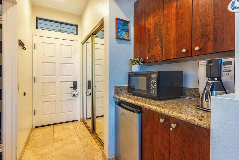 Step into your inviting entryway featuring convenient kitchenette amenities including a microwave, coffee maker, and mini-fridge—everything you need for easy mornings and quick refreshments during your stay.