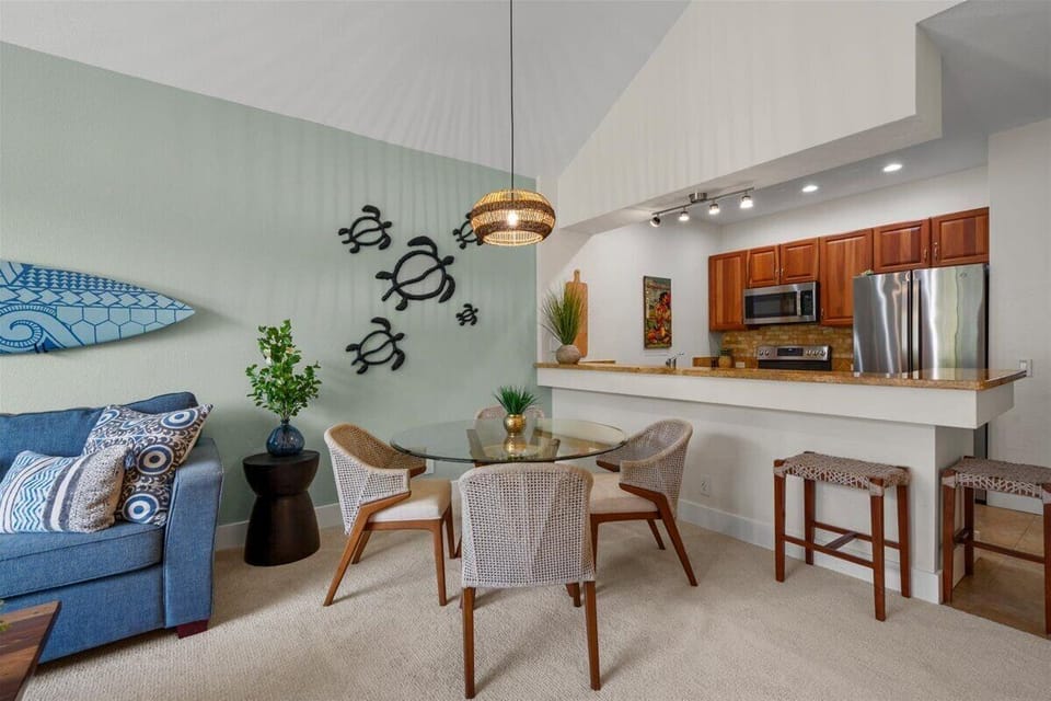 You'll love the open-concept living and dining space, designed to feel breezy and relaxed. The coastal-themed décor and stylish kitchen bar invite you to unwind after a day exploring nearby beaches.