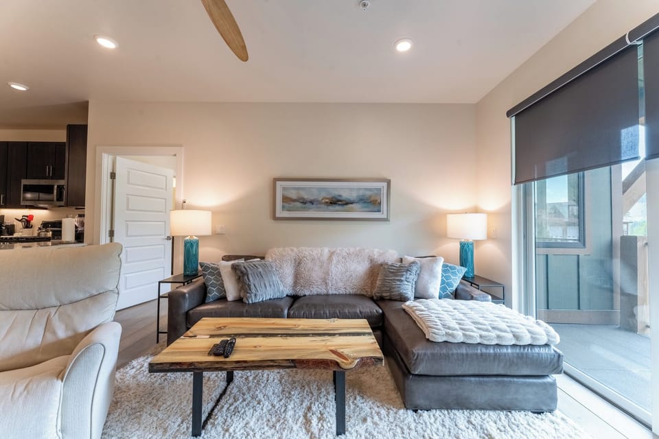 Sink into plush seating where natural light fills your stylish retreat, complete with cozy textures and modern amenities.
