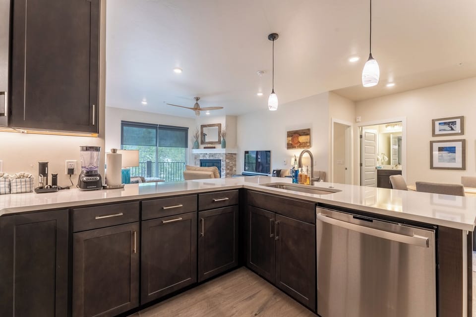 Your spacious kitchen features gleaming granite counters, stainless appliances, and modern cabinets perfect for preparing meals while staying connected to the living area.