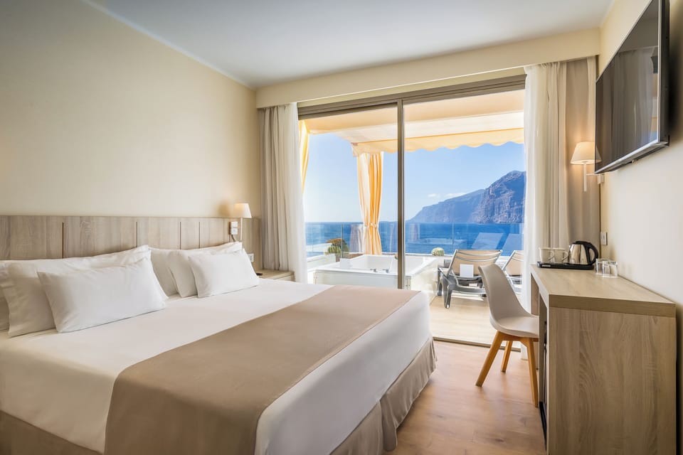 Deluxe Room, Hot Tub, Sea View | Minibar, in-room safe, desk, blackout drapes