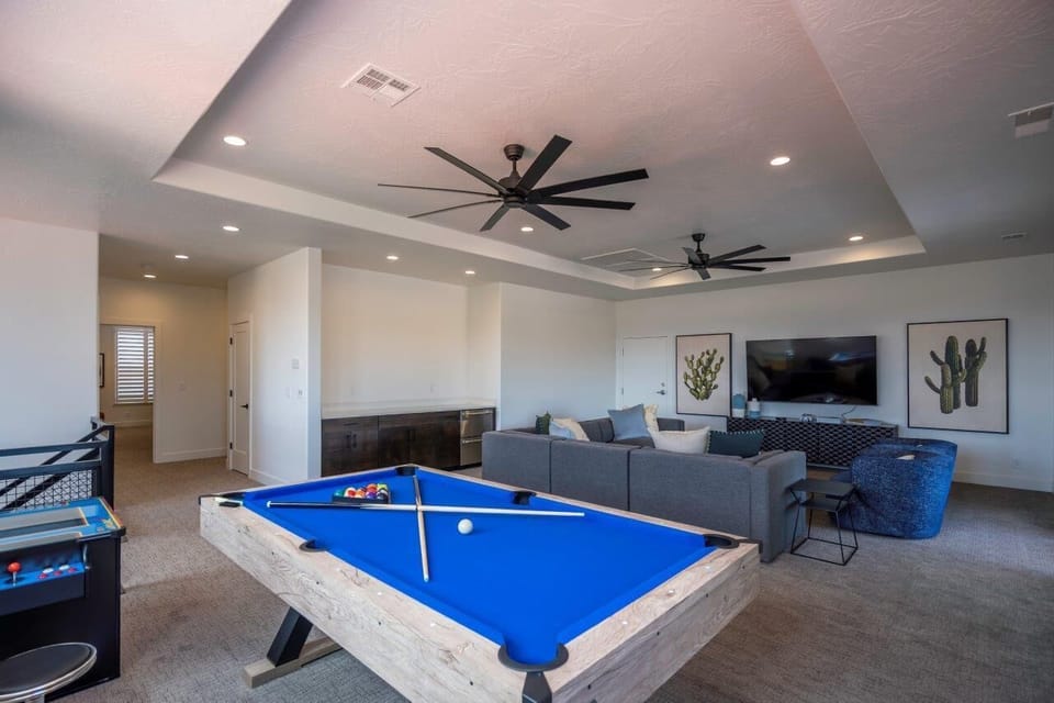 Villa #69 - Upstairs living room with a pool table, arcade, TV, and plenty of seating