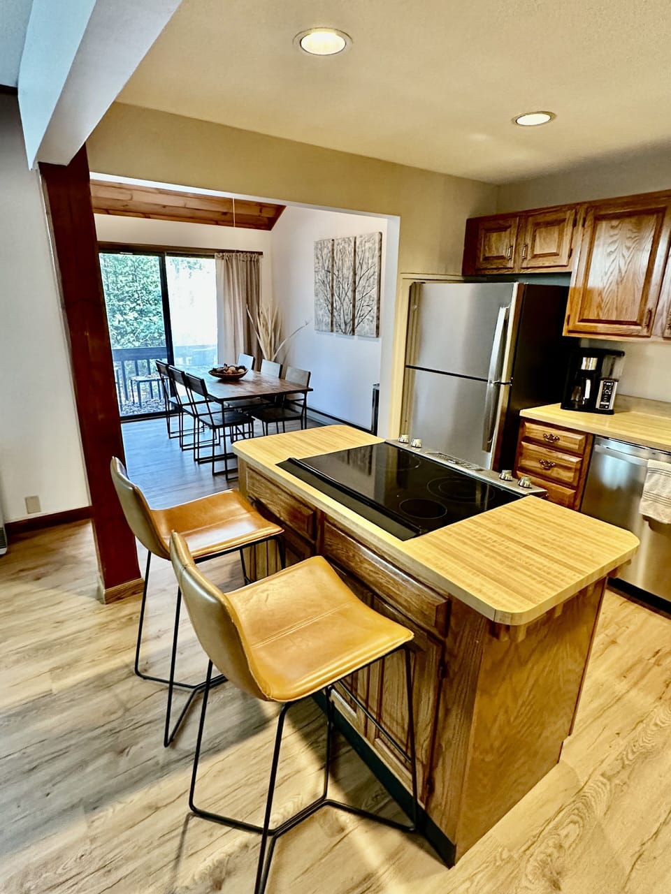 Kitchen and dining, with half bath off dining room with laundry and front deck