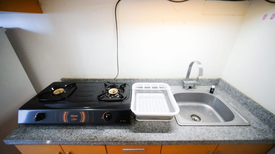Full-size fridge, stovetop, rice cooker, cookware/dishes/utensils