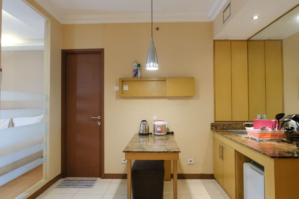 Full-size fridge, stovetop, rice cooker, cookware/dishes/utensils
