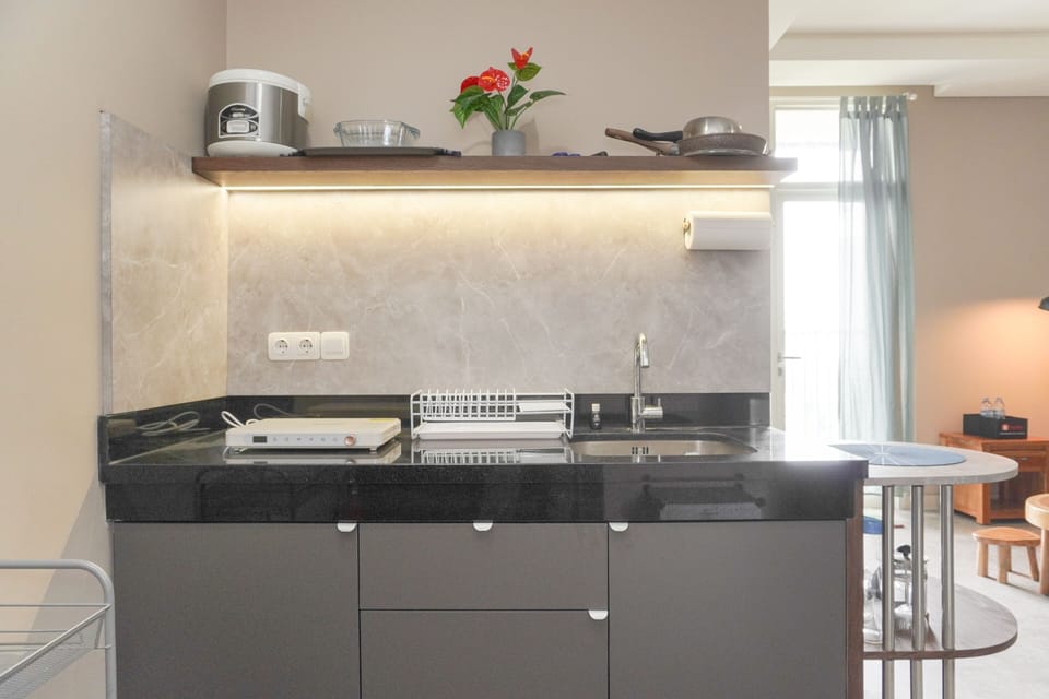 Apartment | Private kitchen | Full-size fridge, stovetop, rice cooker, cookware/dishes/utensils