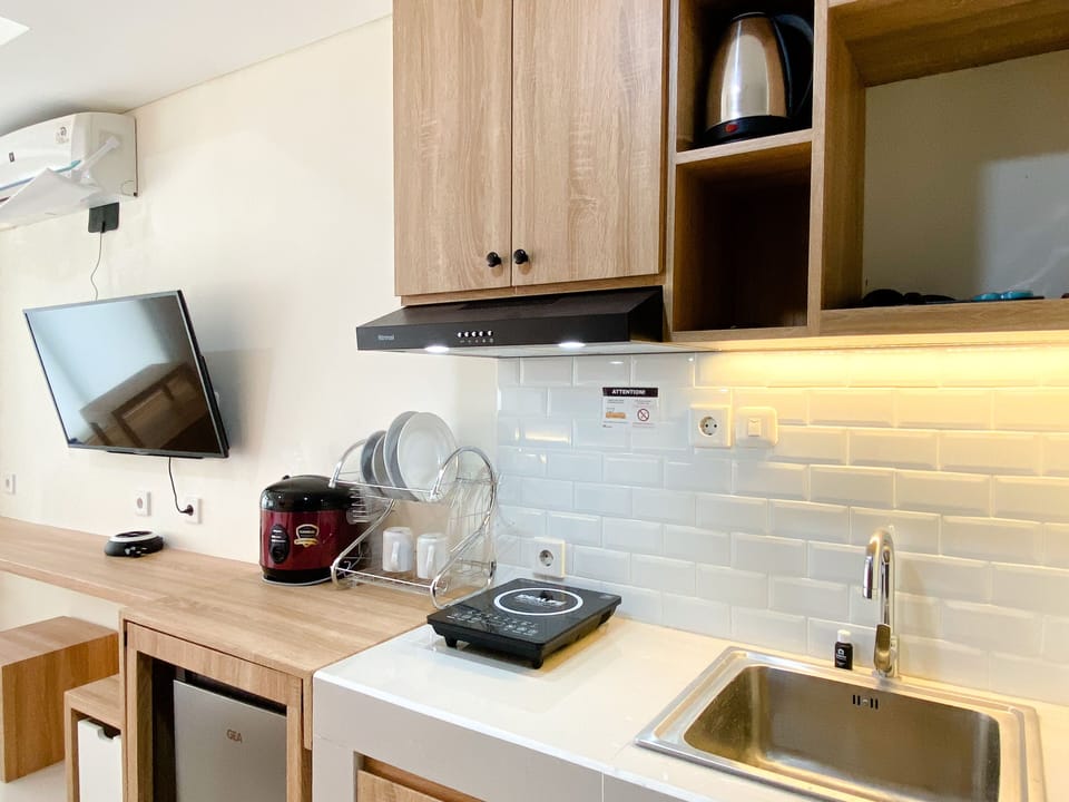 Full-size fridge, stovetop, rice cooker, cookware/dishes/utensils