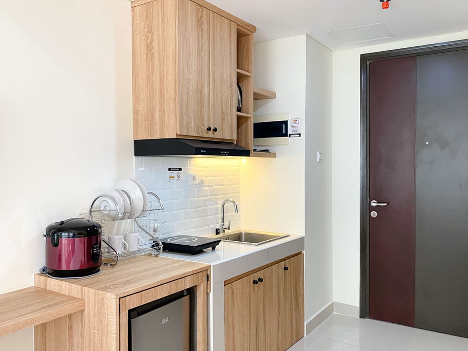Full-size fridge, stovetop, rice cooker, cookware/dishes/utensils