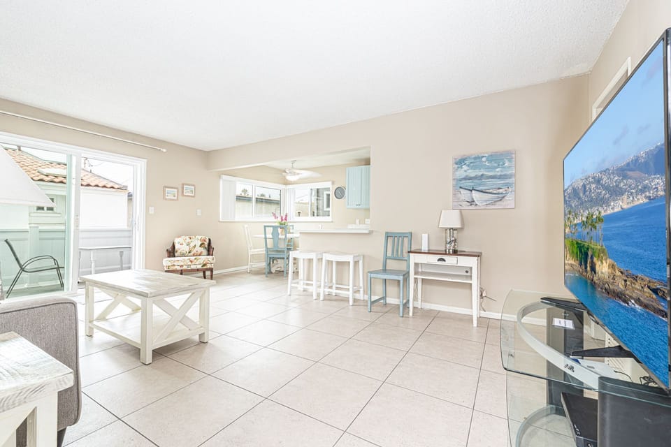 Main living spaces looking from front entry area. Open floor plan between living, kitchen and dining areas.
                