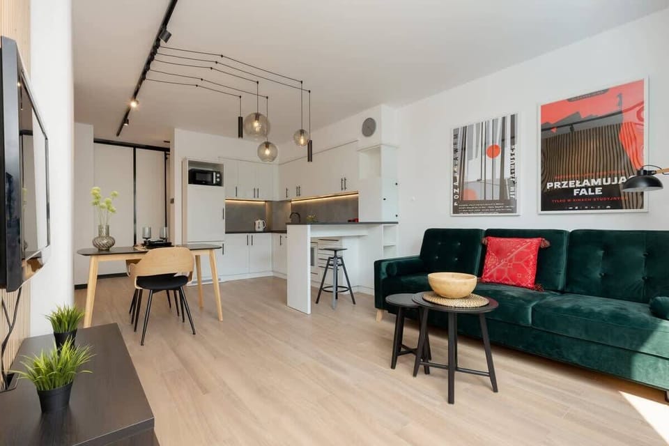 A functional open-plan layout combining the living, dining, and kitchen areas with stylish furnishings.
