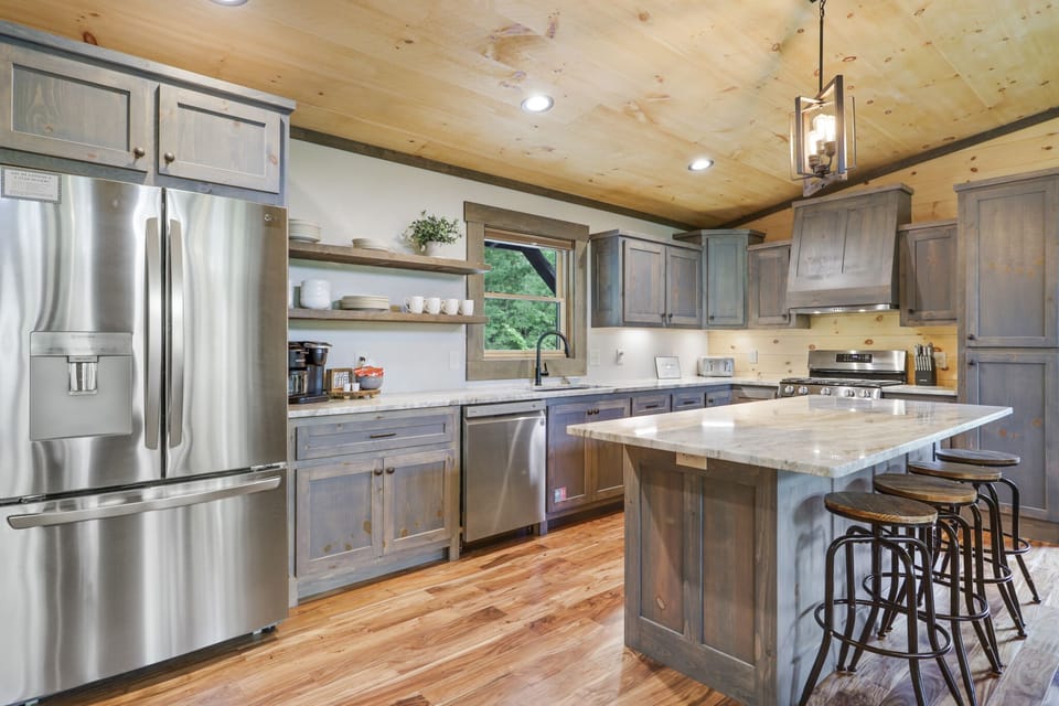 Brand new, fully stocked, stainless steel kitchen with a gas stove.