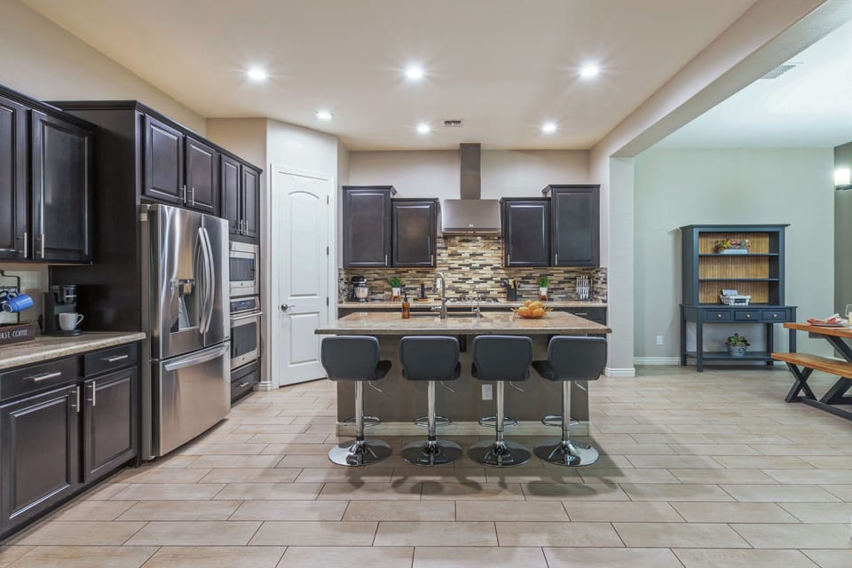 Open concept kitchen has generous counter space and island for prepping and serving your favorite cuisine.